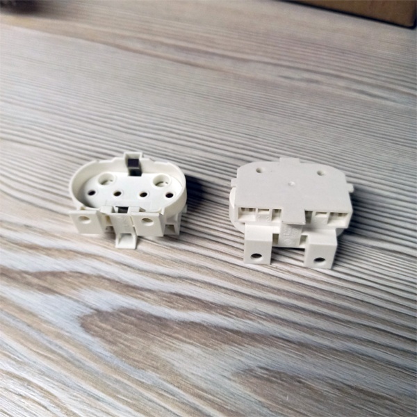 Патрон 2G11 с торцевым и боковым креплением под патроны М3 и М4 для компактных люминесцентных ламп.